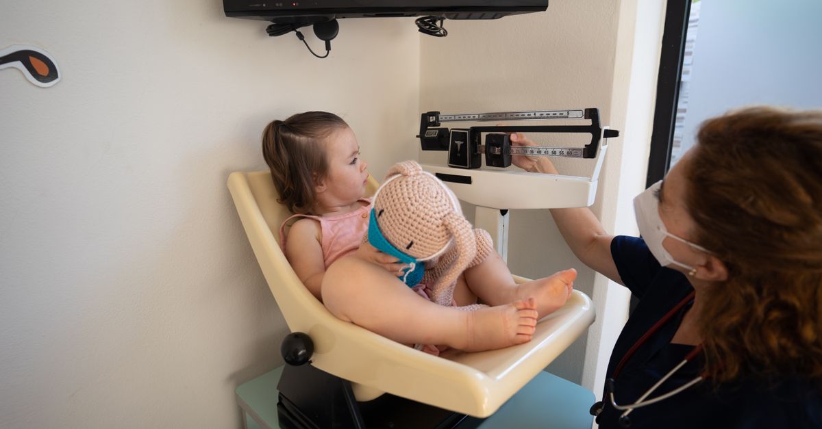 pediatrician doctor examining child at hospital emergency room